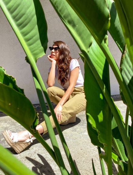 Girl posing in front of palm trees